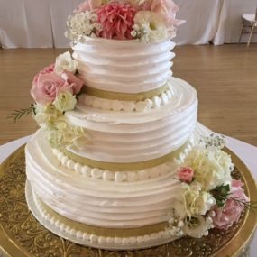 wedding cake tiered with pink flowers