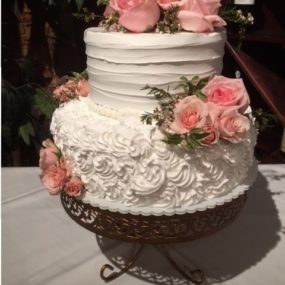 wedding cake with pink flowers and tiered