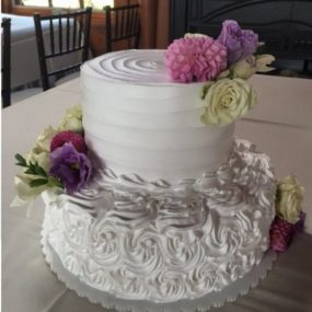 wedding cake with pink and purple flowers